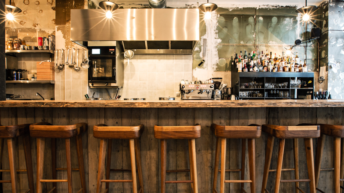 Inside Dersou a wooden bar, with white walls, and cocktails.