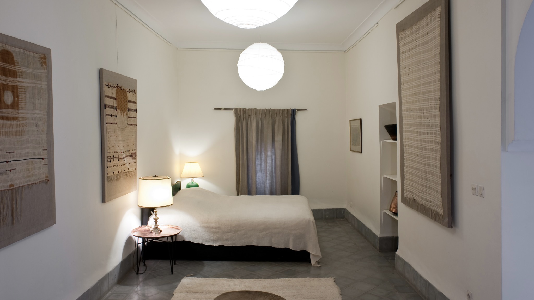 Bedroom with white decor, art on the wall inspired by Morrocan style