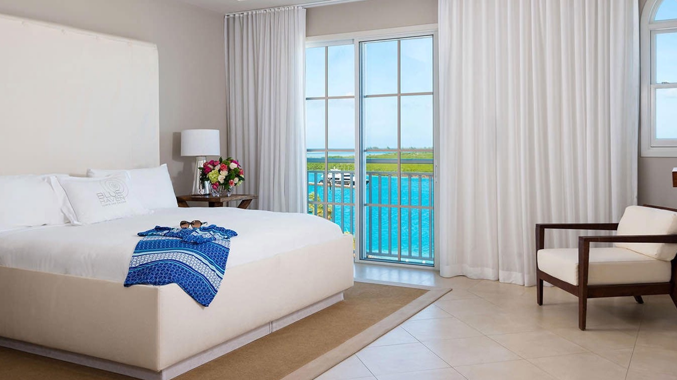 a room at The Blue Haven Resort with a view of the beach from the window