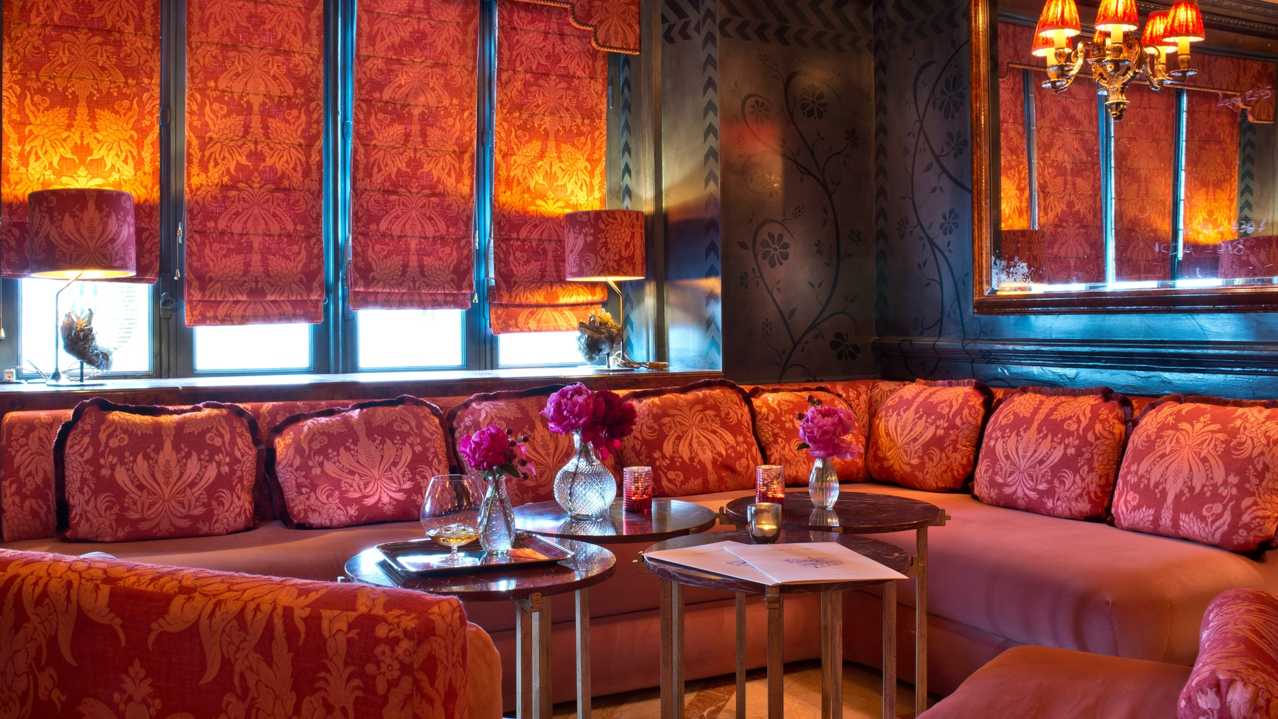 Inside Laperouse bar, red sofas, red rouses and windows and red decor.