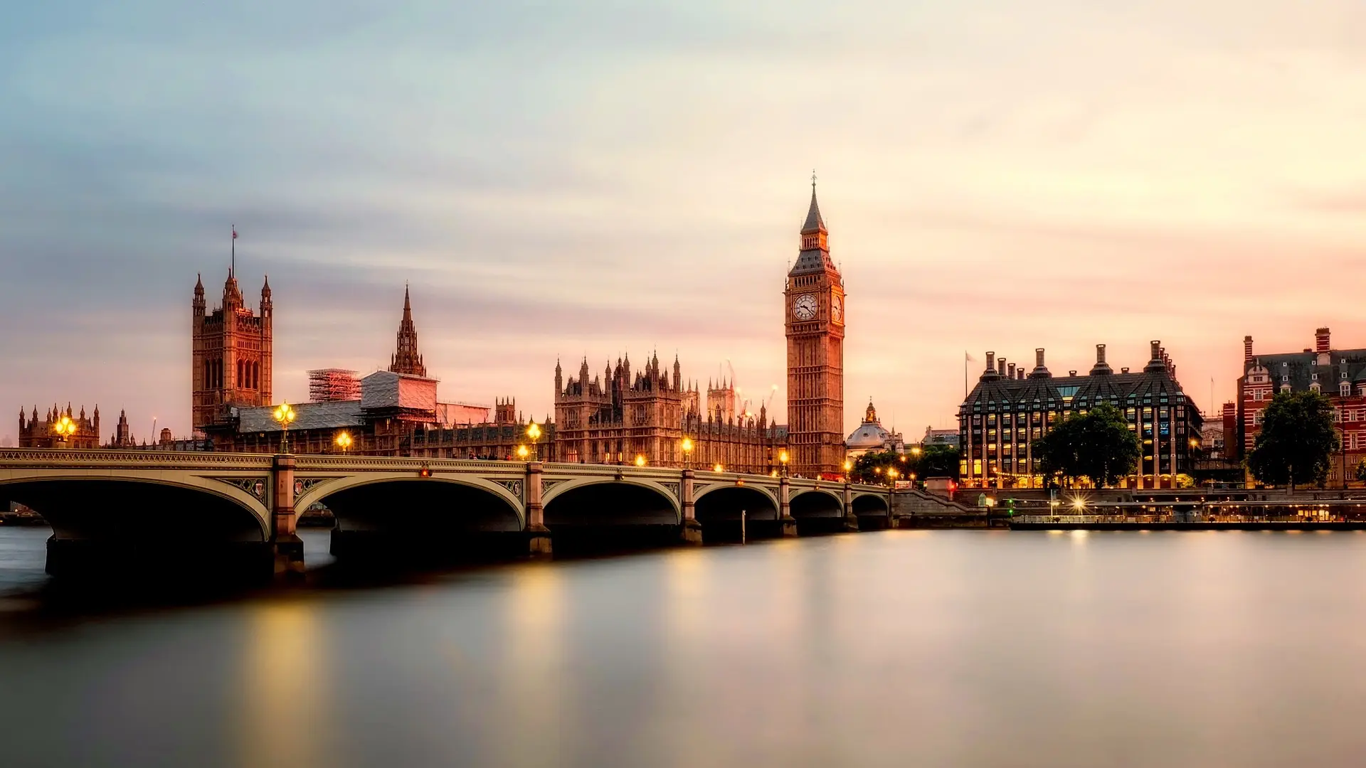 View from the water to the westminster bridge, BigBen clock tower and a beautiful sunset lighting.