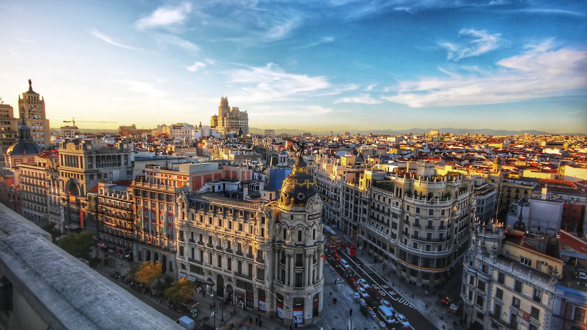 Bird view of the heart of Madrid, Spain, with a lot of buildings all in a stone white colour and sun setting any minute.