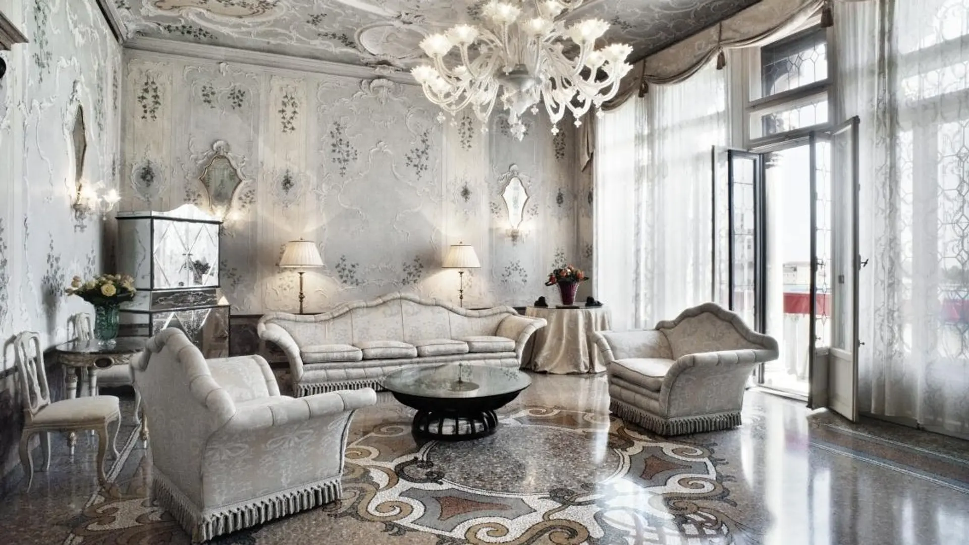 Grand living room with marble floor and white interior at Hotel Bauer Palazzo