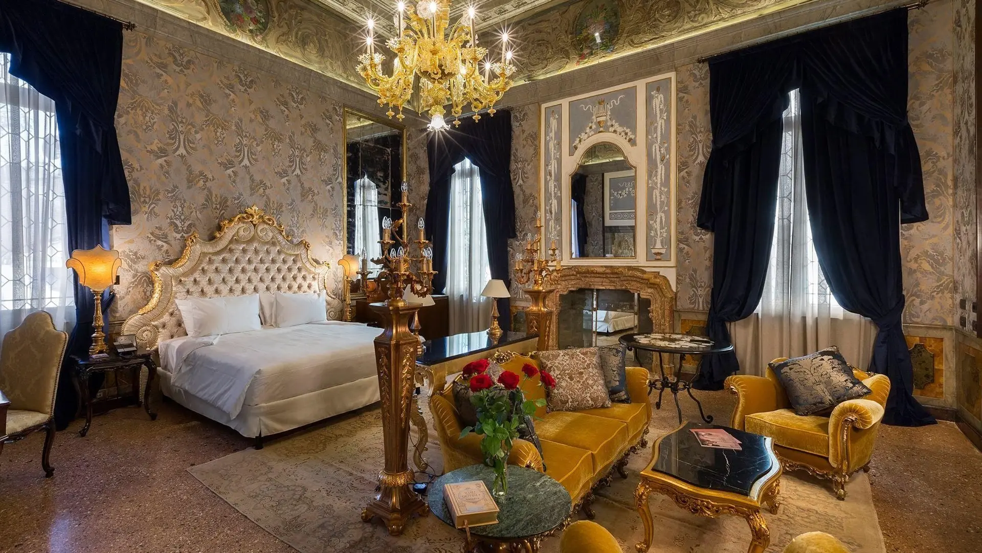 Grand suite bedroom at Palazzo Venart with large space, kingsize bed and couches