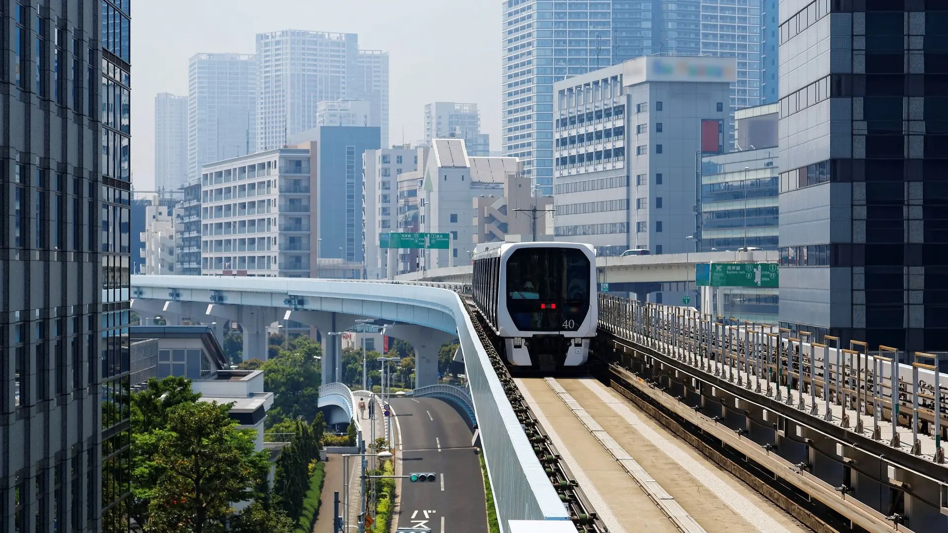 Tokyo Monorail, white train passing through the city.