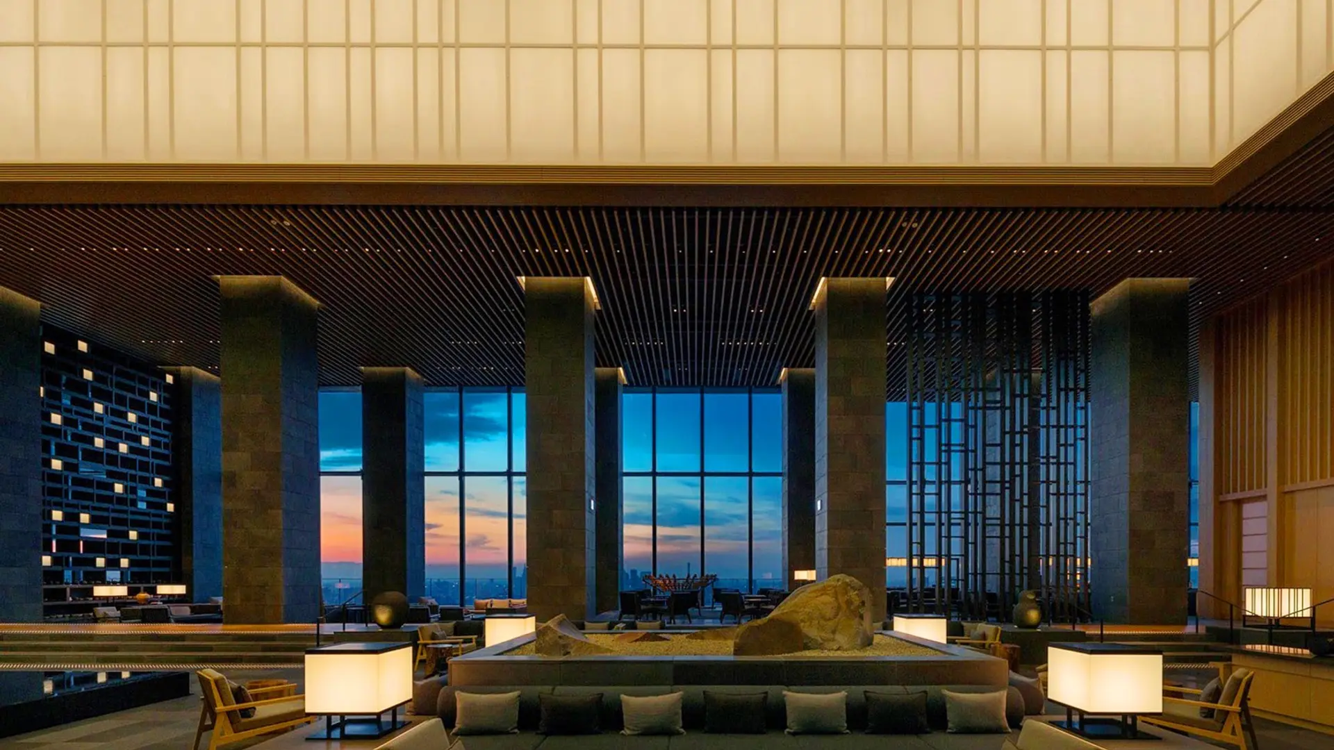 Suite at Aman Tokyo with traditional Japanese design and stunning glass view of Tokyo.