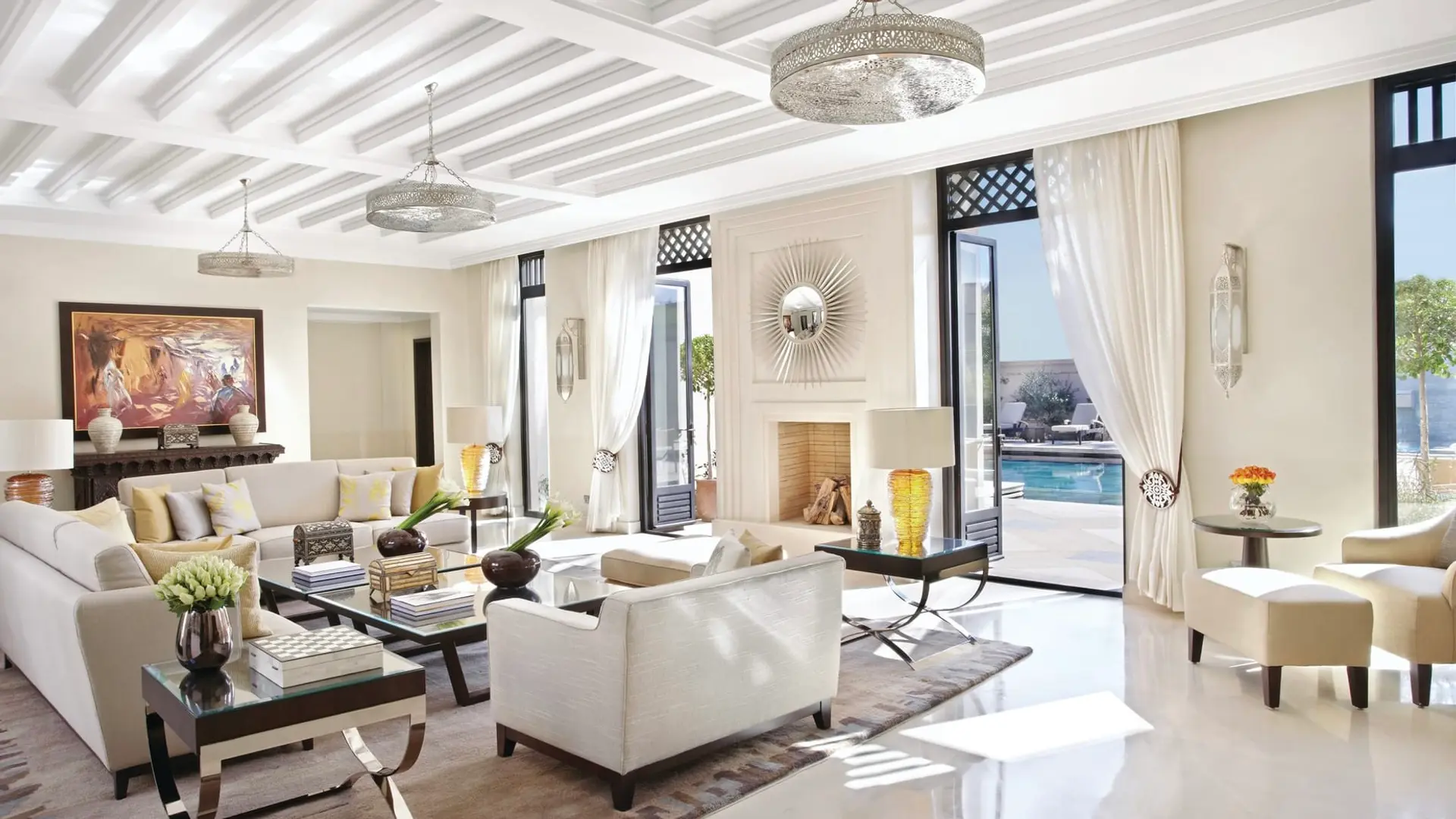 Spacious living room with white decor and art at Four Seasons Marrakesh