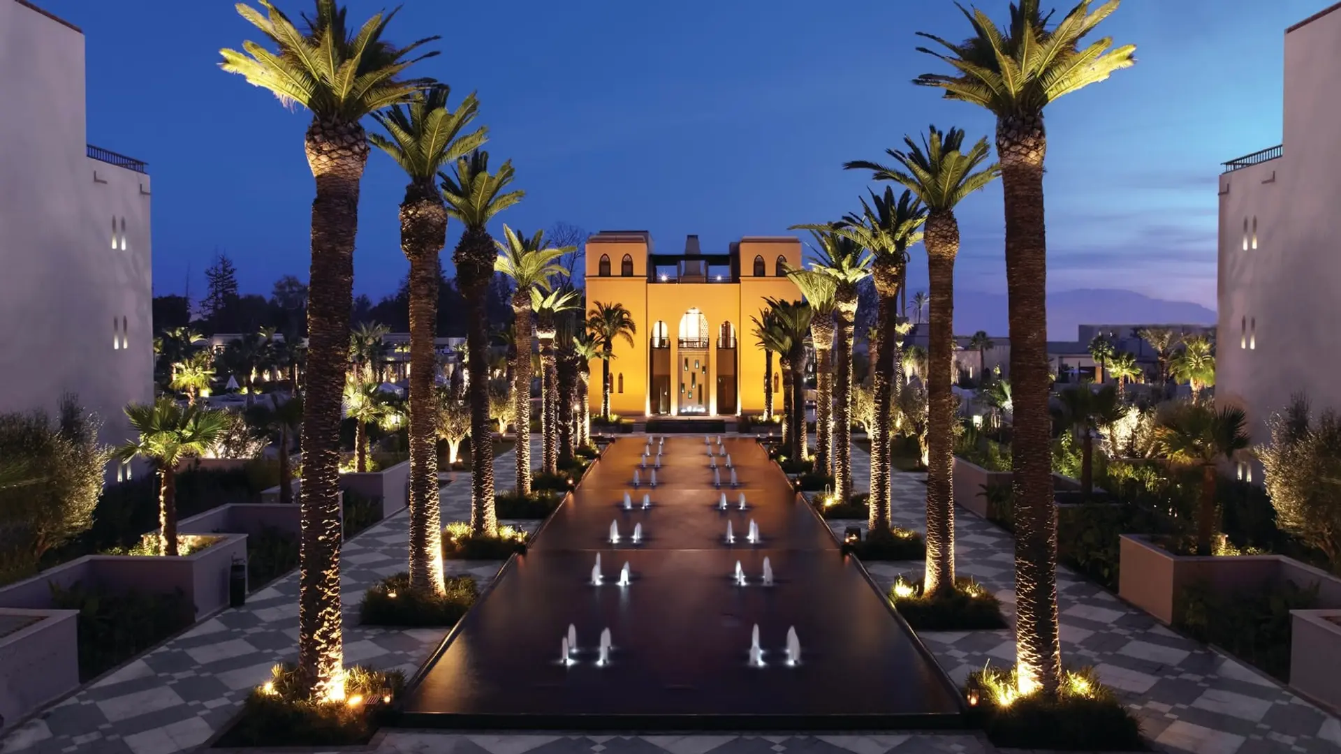Palm trees, fountains and the pastel orange Four Seasons entrance