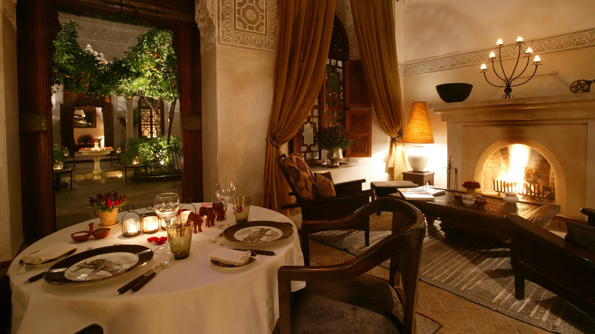A private dining room with ancient wall engravings and a fireplace area with seats