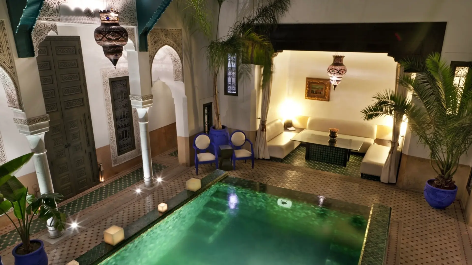 Green coloured pool, sofa under the rood and white design at Riad Farnatchi